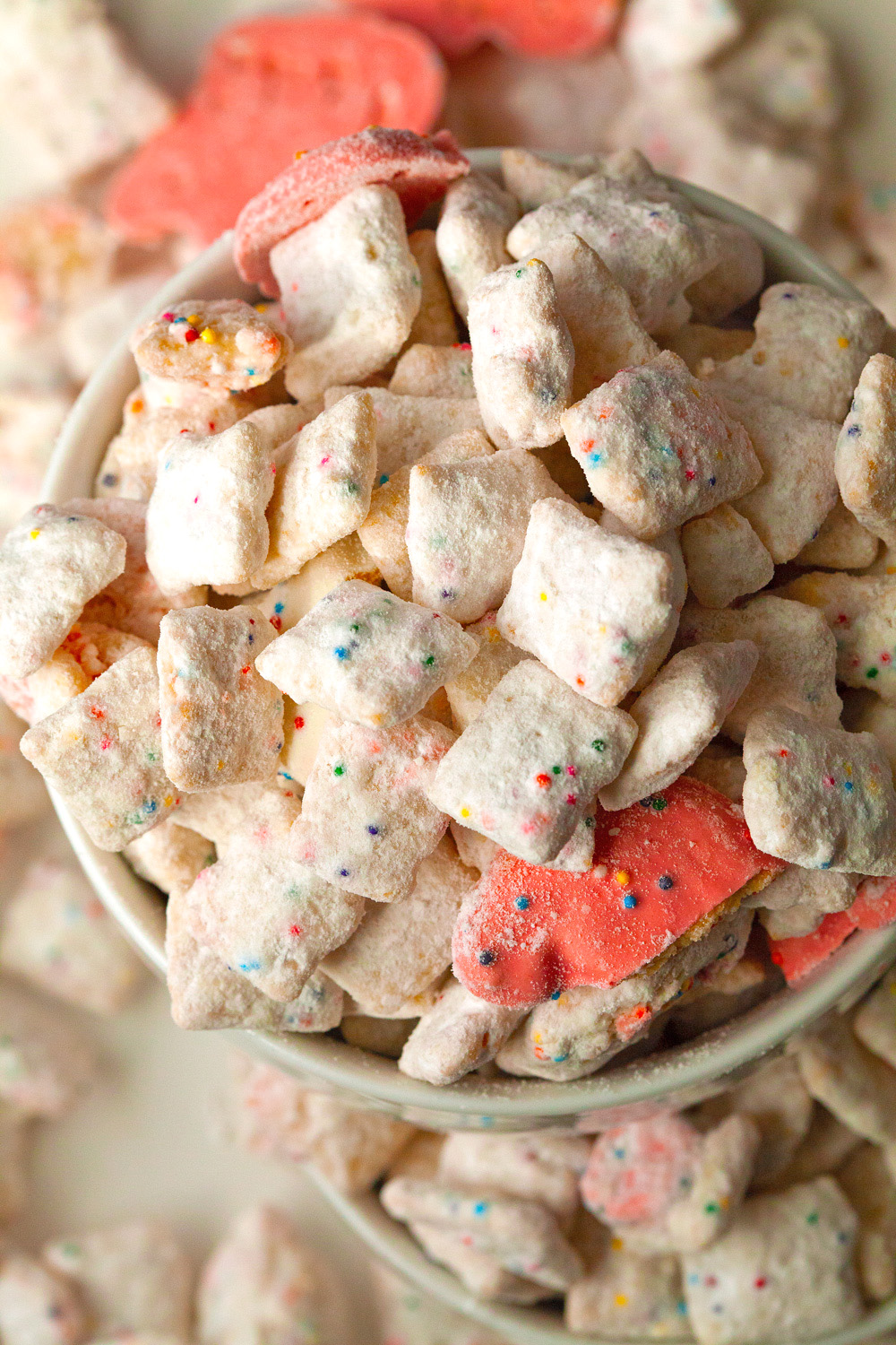 Frosted Animal Cracker Confetti Cake Muddy Buddies via Deliciously Yum!